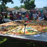 Sixteen teams created slices for this giant pizza.